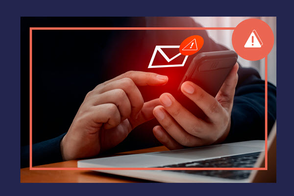 Someone using a smart phone with a warning icon displayed, suggesting there could be security issues.